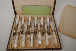 A boxed set of twelve silver plate tea knives and forks with mother of pearl handles, and a silver