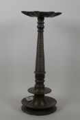 An antique Indian bronze incense burner with shaped top and ring turned column, 39cm high