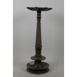 An antique Indian bronze incense burner with shaped top and ring turned column, 39cm high