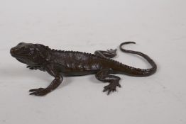A Japanese style bronze okimono lizard, mark to base, 13cm long