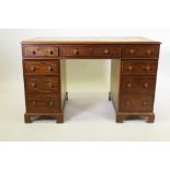C19th mahogany nine drawer pedestal desk, the cockbeeded drawers with brass handles and leather