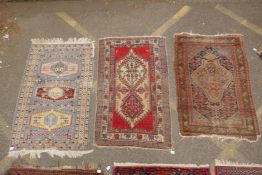 A Persian blue ground wool rug with geometric medallions and stylised birds design, a red ground