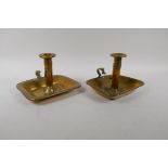 A pair of Georgian brass ejector chamber sticks with rectangular  drip trays, AF, 18cm x 17cm,