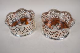 A pair of silver plate and faux tortoiseshell wine coasters, 5" diameter