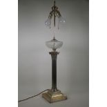 A Victorian silver plated Corinthian column table lamp with glass reservoir, converted to