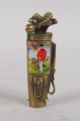 A brass vesta case in the form of a golf bag, set with a cold enamel plaque depicting a Victorian