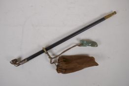 A Chinese bronze mounted hardwood pipe with a carved celadon jade dog toggle, 35cm long