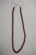 A string of horn beads, 88cm long