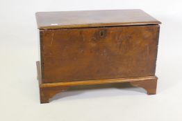 A C19th mahogany planked coffer, the interior fitted with a candle box, raised on bracket