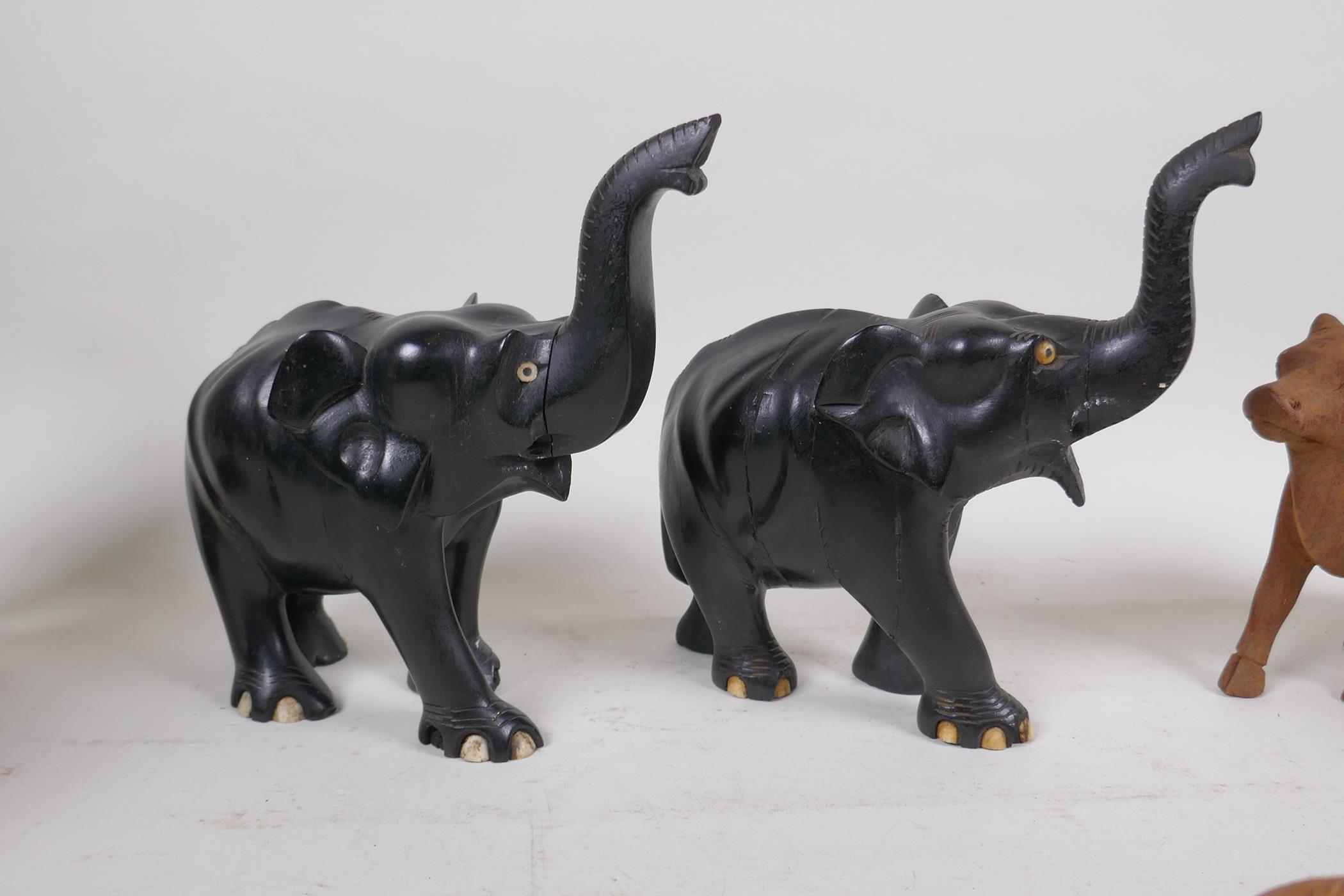 A collection of Indian carved wood animals including a pair of ebony elephants, cows etc, largest - Image 3 of 5