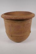 An eastern terracotta planter with engraved and embossed decoration, 40cm diameter, 35cm high