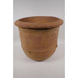 An eastern terracotta planter with engraved and embossed decoration, 40cm diameter, 35cm high