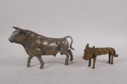 A white metal figure of a bull, 21cm long, and an African bronze figure of a lion
