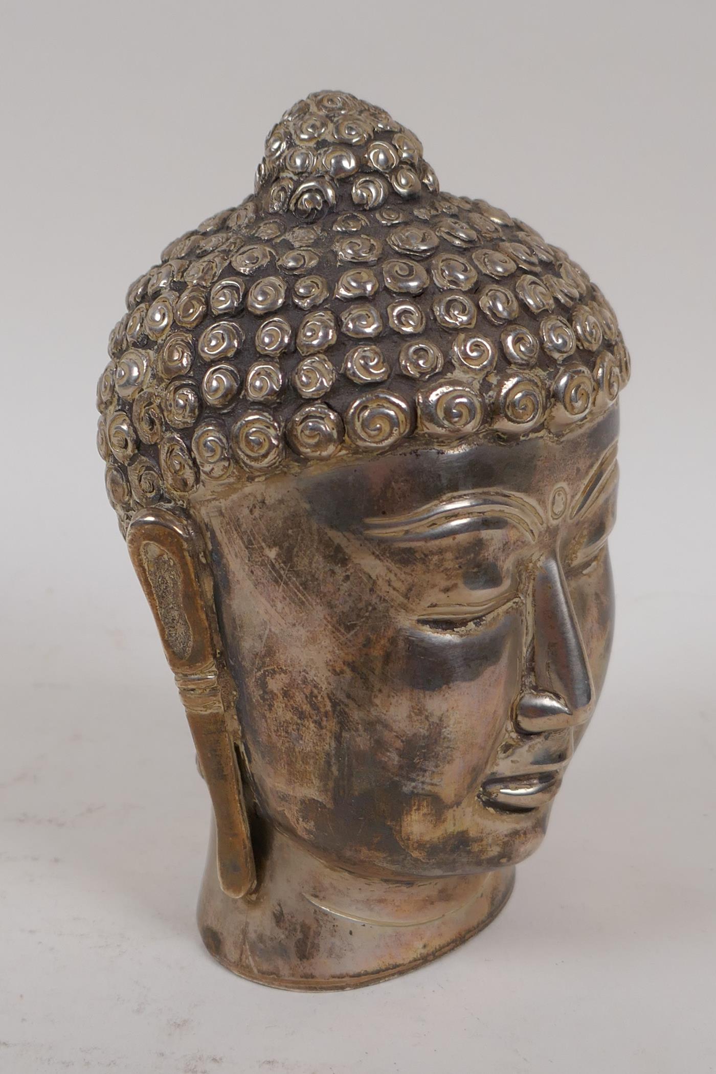 A tested silver model of Buddha's head, 14cm high, 310g