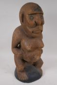 A tribal carved wood fertility figure, 50cm high