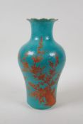 A turquoise ground porcelain vase with a petal shaped rim, decorated in iron red with birds and
