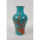 A turquoise ground porcelain vase with a petal shaped rim, decorated in iron red with birds and