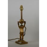 An antique brass table lamp in the form of a cherub, 40cm high