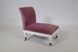 A C19th painted mahogany gout stool, with ratcheted top, raised on turned supports with brass and
