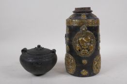 A Tibetan brass mounted wood cylinder pot decorated with mythical creatures and a wrathful deity