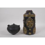 A Tibetan brass mounted wood cylinder pot decorated with mythical creatures and a wrathful deity