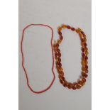 A string of vintage amber beads (51g) and a coral beaded necklace, longest 96cm