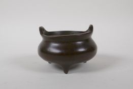 A Chinese bronze censer with two phoenix eye handles and tripod feet, 4 character mark to base, 10cm