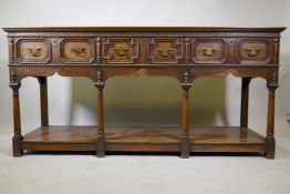 A Georgian style oak side board/dresser with bobbin turned decoration and three drawers with moulded