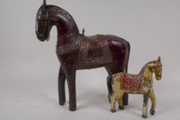 An Indian carved model of a horse with engraved metal saddle and tack, 30cm high, and a small wooden