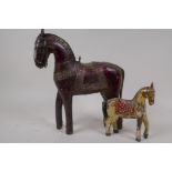 An Indian carved model of a horse with engraved metal saddle and tack, 30cm high, and a small wooden