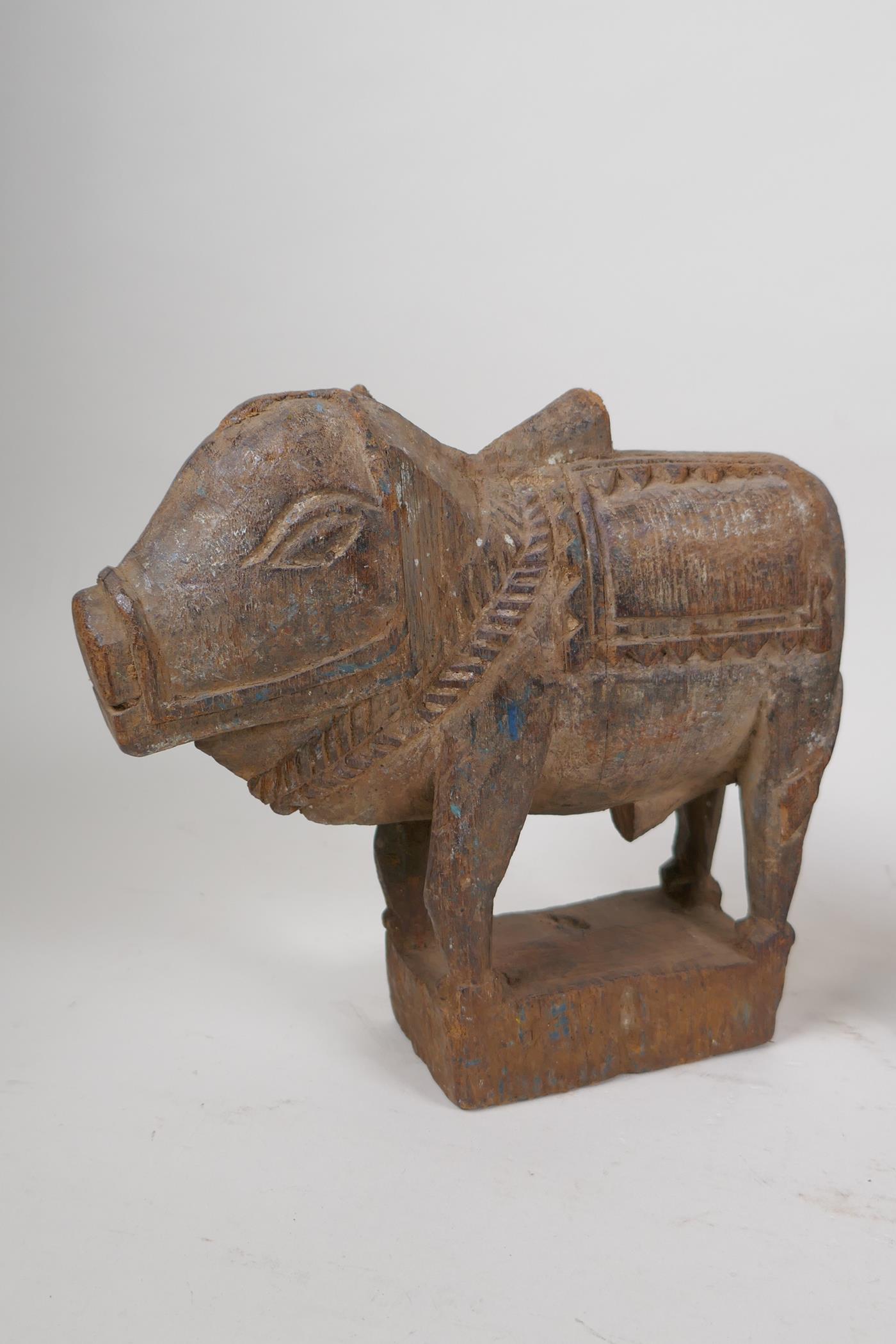 A collection of Indian carved wood animals including a pair of ebony elephants, cows etc, largest - Image 2 of 5