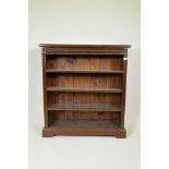 A mahogany open bookcase, with moulded frieze and carved paterae decoration and three adjustable