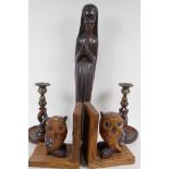 A carved wood figure of a nun, 47cm high, and a pair of barley twist oak candlesticks, and a pair of