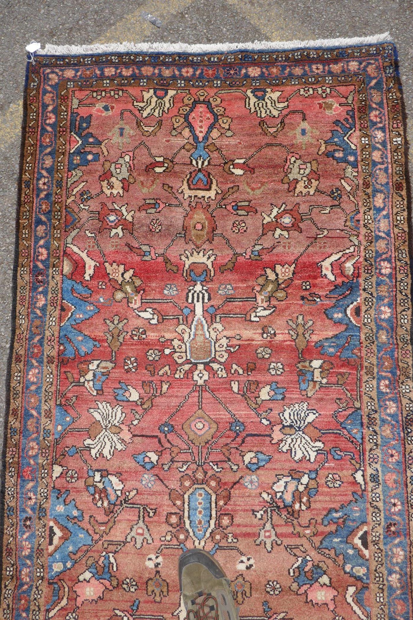 A washed terracotta ground Persian Hamadan runner, with all over floral pattern, 108cm x 284cm - Image 4 of 6