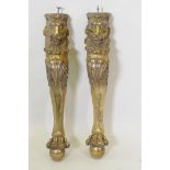 A pair of gilt composition table legs in the form of lions, with paw feet, 78cm high