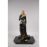 An Art Deco style cold painted bronze figure of a woman with feather fan, on a polished stone