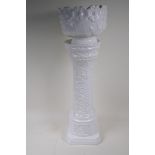 A German white glazed pottery jardiniere on stand with embossed flower and vine decoration, 67cm