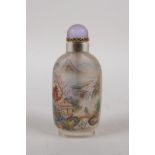 A Chinese reverse decorated glass snuff bottle depicting a riverside landscape and objects of