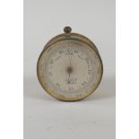 An antique British made brass pocket barometer, thermometer and compass by Halletts of Hastings, 5cm