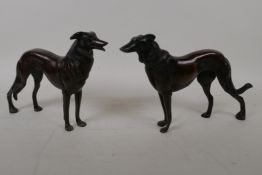 A pair of bronze figures of hounds, 27cm long