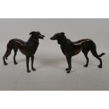 A pair of bronze figures of hounds, 27cm long