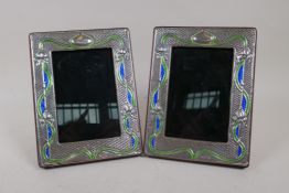 A pair of enamelled sterling silver photograph frames in the Art Nouveau style, aperture 4" x 5"