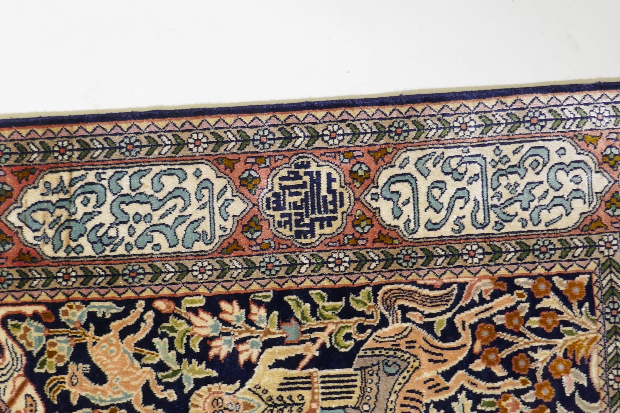 A caucasian fine silk rug with a leopard hunt design on a blue field, the red borders decorated with - Image 5 of 7