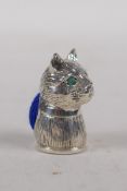 A miniature 925 silver cats head pin cushion with emerald set eyes, 2.5cm long