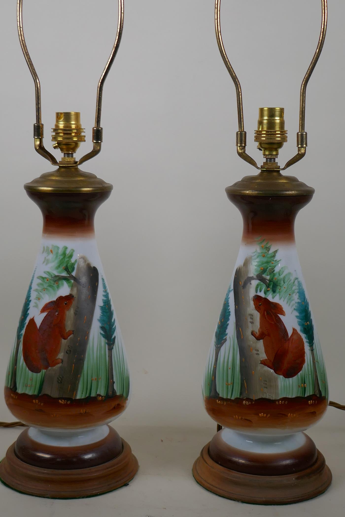 A pair of opaline glass table lamps with hand painted decoration of red squirrels amongst pine - Image 2 of 2