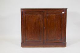 A C19th mahogany two door side cupboard with cut corners, raised on a plinth base, 98 x 37 x 81cm