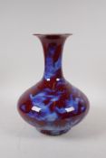 A Chinese blue and red flambe glazed porcelain vase, 28cm high