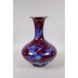 A Chinese blue and red flambe glazed porcelain vase, 28cm high