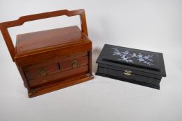 A Chinese lacquered jewellery box with mother of pearl inlay to the cover, 31cm long, and a hardwood