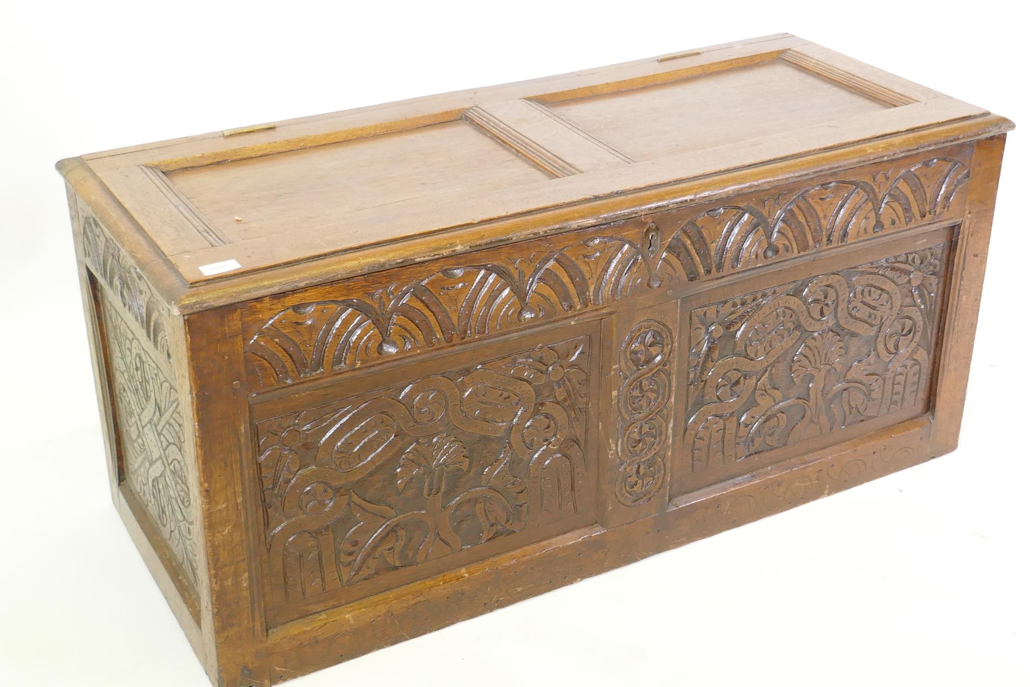 An C18th oak coffer with two carved panels and frieze and panelled top, 116 x 49 x 52cm - Image 2 of 4